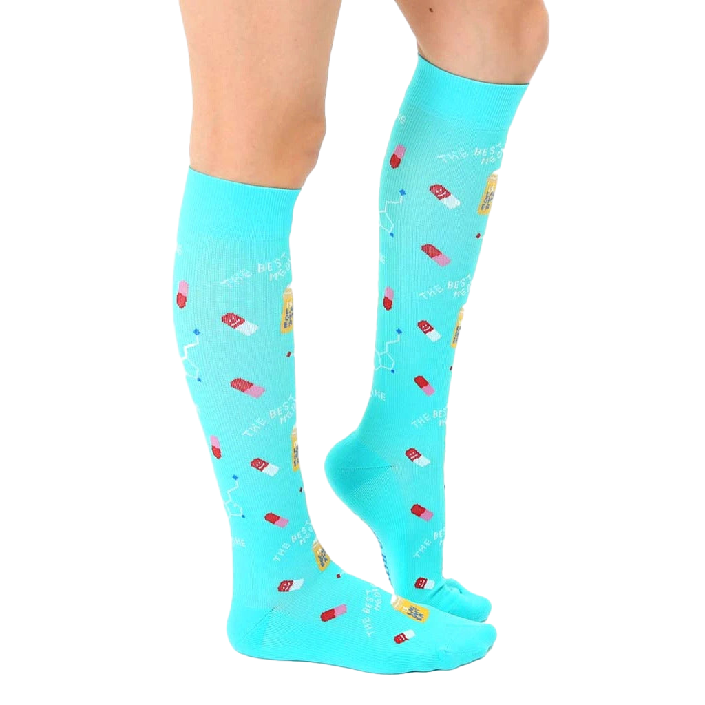 Lifestyle shot of a person wearing the turquoise "Best Medicine" knee-high socks. [lf]