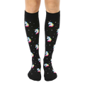 Pair of black knee-high socks with a pattern of rainbow pixel unicorn heads and small white stars. [lf]