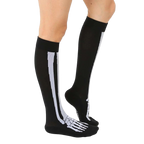 Lifestyle shot of a person wearing black knee-high skeleton socks. The socks are slightly angled, showing off the design. [lf]