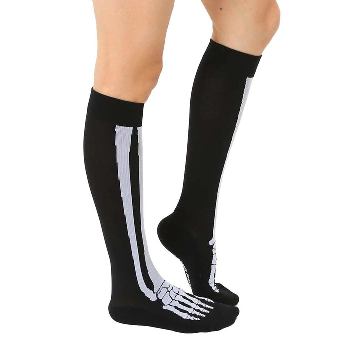 A pair of black knee-high socks with a white skeleton print.