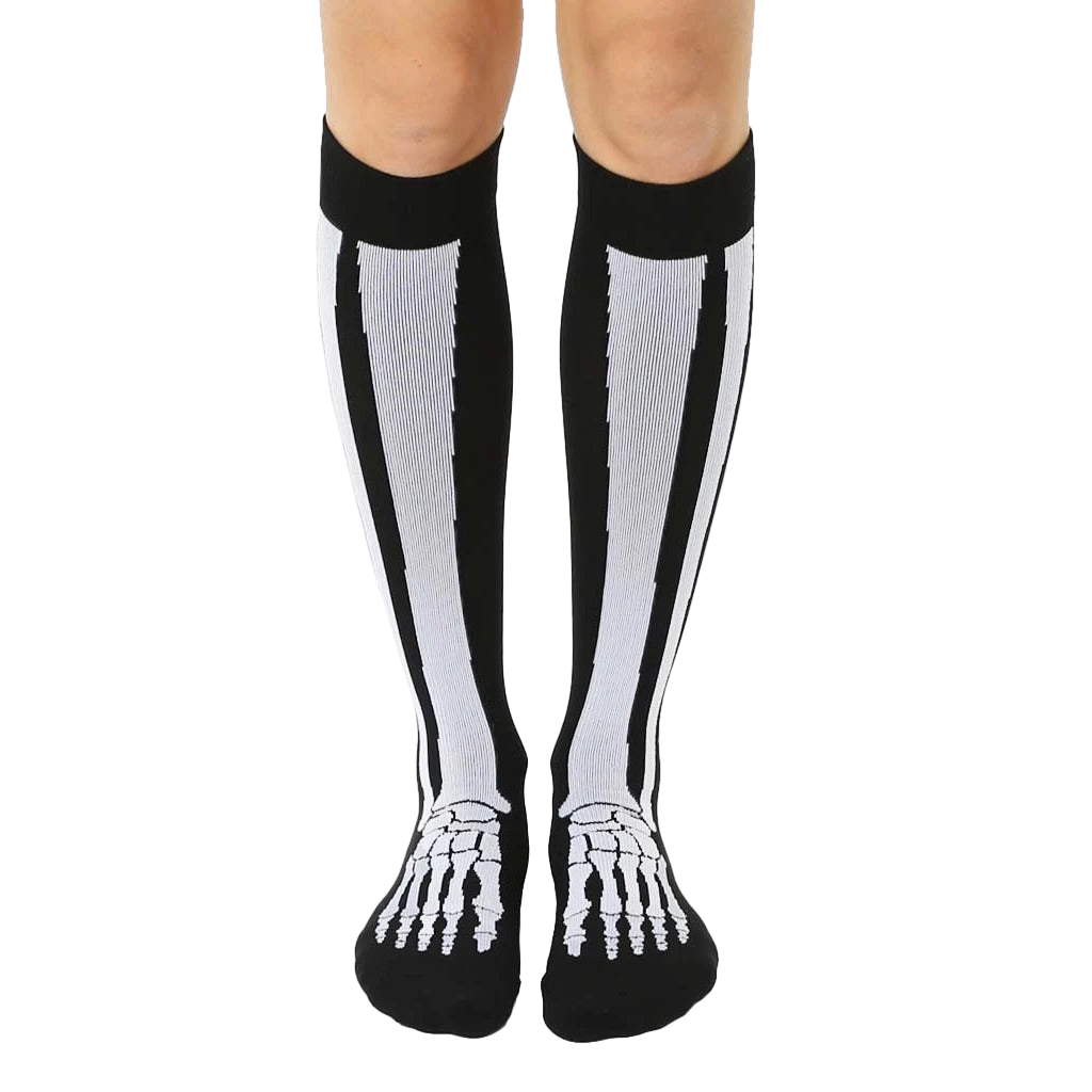 Pair of black knee-high socks with a white skeleton design. The bones run vertically up the leg and across the feet. [lf]