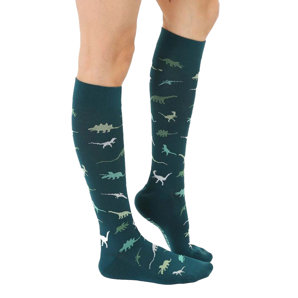 Lifestyle shot showing the teal dinosaur socks on a person's legs. [lf]