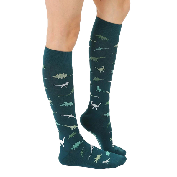 Lifestyle shot showing the teal dinosaur socks on a person's legs. [lf]