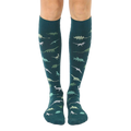 Pair of teal knee-high socks with a pattern of various green and teal dinosaurs. [lf]