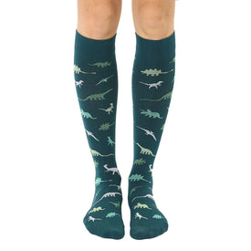 dark green knee-high socks with a pattern of dinosaurs in various shades of green and white.  