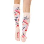 Close-up view of the back of the socks, showing the 'Living Royal' logo on a light pink background. The floral pattern is also clearly visible. [lf]