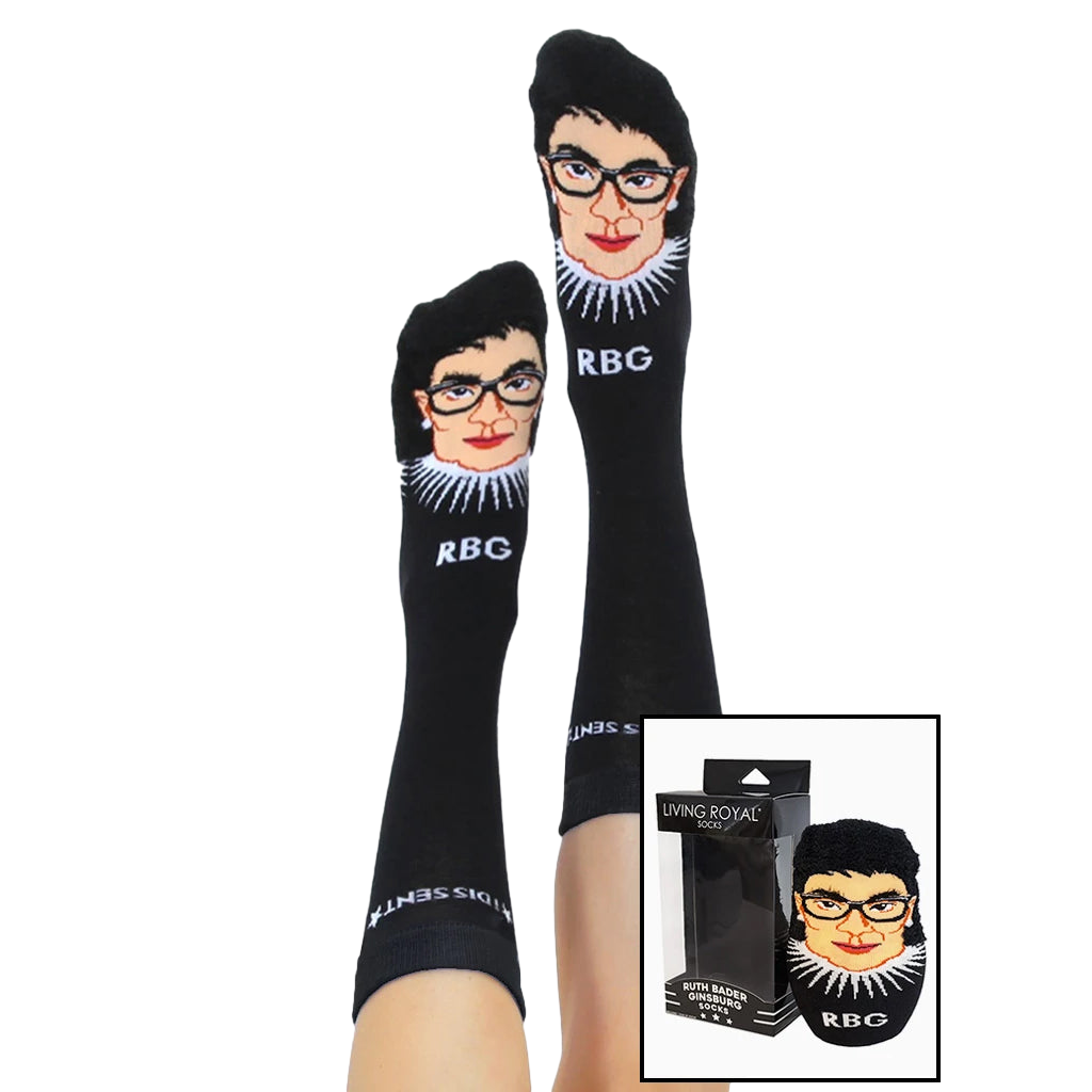 Lifestyle shot of a person wearing the Ruth Bader Ginsburg socks with the socks' packaging shown alongside. [lf]