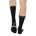 Back view of a pair of Ruth Bader Ginsburg socks worn, displaying the 'Living Royal' logo on the heel. [lf]