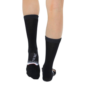A pair of black socks with a white Living Royal logo on the left sock and a red and white Living Royal logo on the right sock.