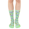 A pair of light green crew socks with a whimsical design featuring cartoonish dollar bills and toilet paper rolls. [lf]