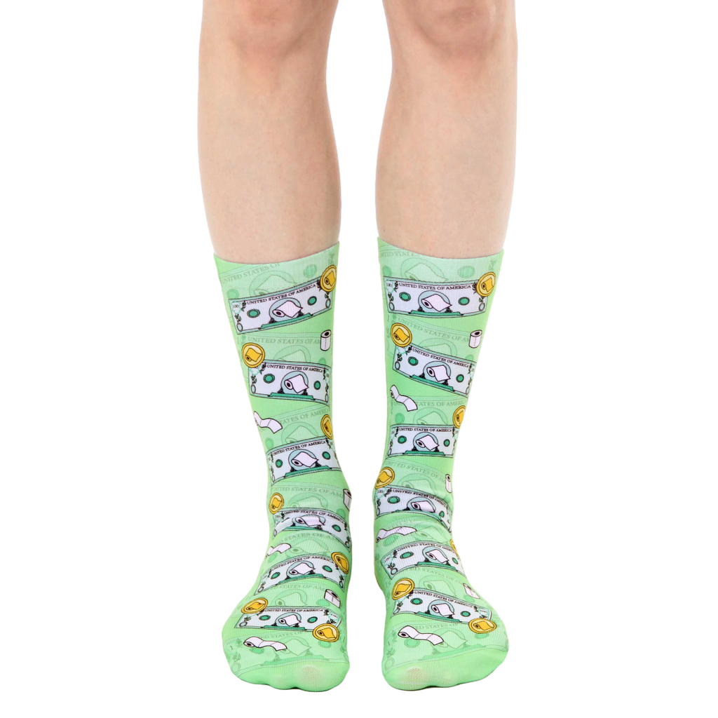 A pair of light green crew socks with a whimsical design featuring cartoonish dollar bills and toilet paper rolls. [lf]