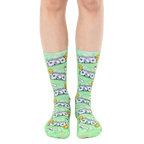 A pair of light green crew socks with a whimsical design featuring cartoonish dollar bills and toilet paper rolls. [lf]