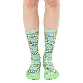 green crew socks with a pattern of hundred dollar bills with toilet paper rolls, designed to fit men and women.   