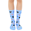 Pair of light blue crew socks with a graduation theme. The design includes black graduation caps, diplomas, and colorful balloons. [lf]