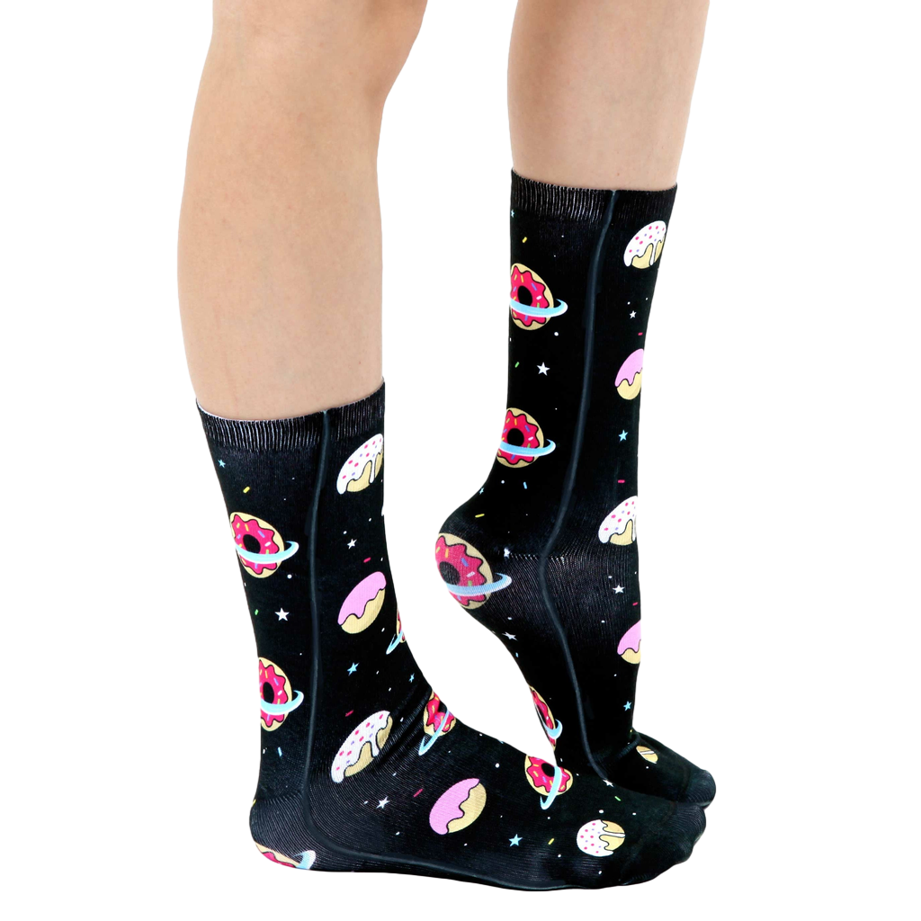 Lifestyle shot of a person's legs wearing the Galaxy Donut socks, showcasing the socks' fit and design. [lf]