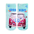 A pair of teal tie-dye crew socks.  They feature a pink VW bus with peace signs and flower stickers. The words 'Good Vibes' are displayed.