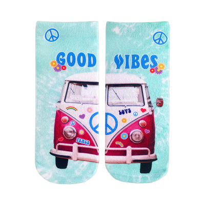 A pair of teal tie-dye crew socks.  They feature a pink VW bus with peace signs and flower stickers. The words 'Good Vibes' are displayed.