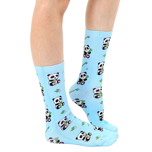 Lifestyle shot of model wearing light blue panda bamboo socks. [lf]