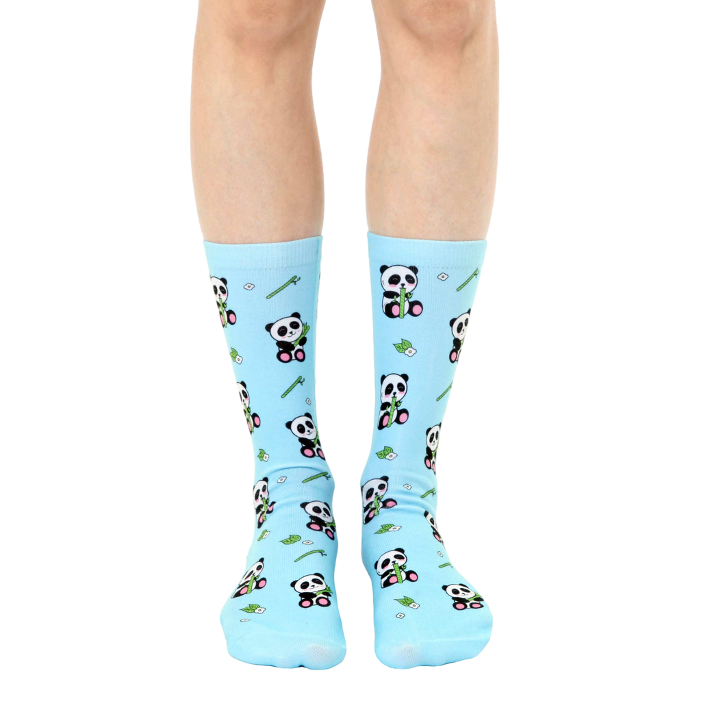 Pair of light blue crew socks with an all-over print of pandas eating bamboo. [lf]