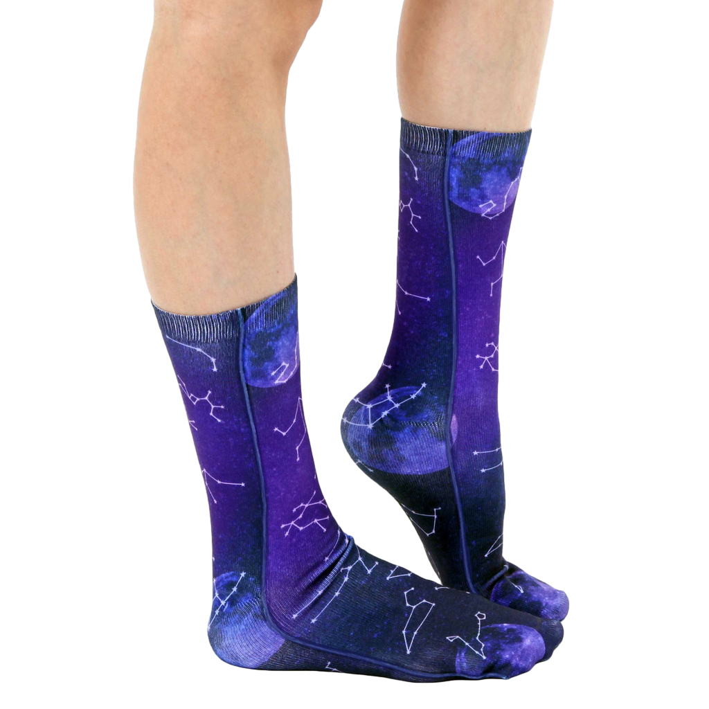 Lifestyle shot of model wearing the Astrology socks, showing the socks from the side and slightly angled. [lf]