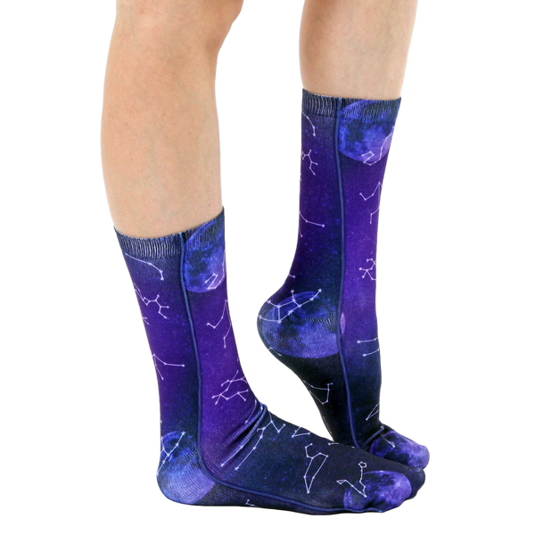 Lifestyle shot of model wearing the Astrology socks, showing the socks from the side and slightly angled. [lf]