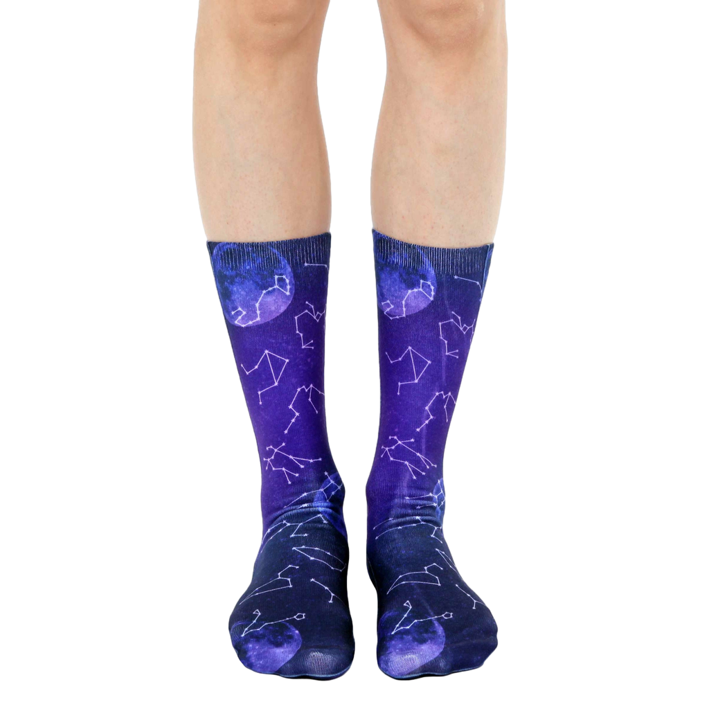 Pair of crew socks in purple and blue gradient.  Design features constellations and moons. [lf]