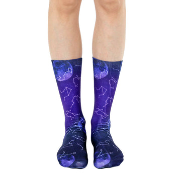 purple crew socks with a pattern of blue and purple constellations and moons, perfect for space enthusiasts.  