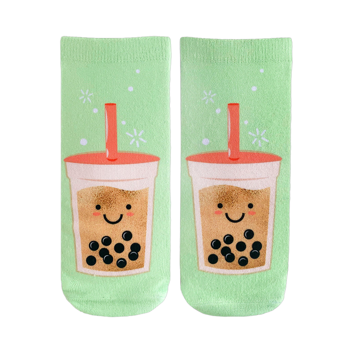 Pair of pastel green crew socks featuring a whimsical illustration of happy boba tea cups with tapioca pearls.  }}