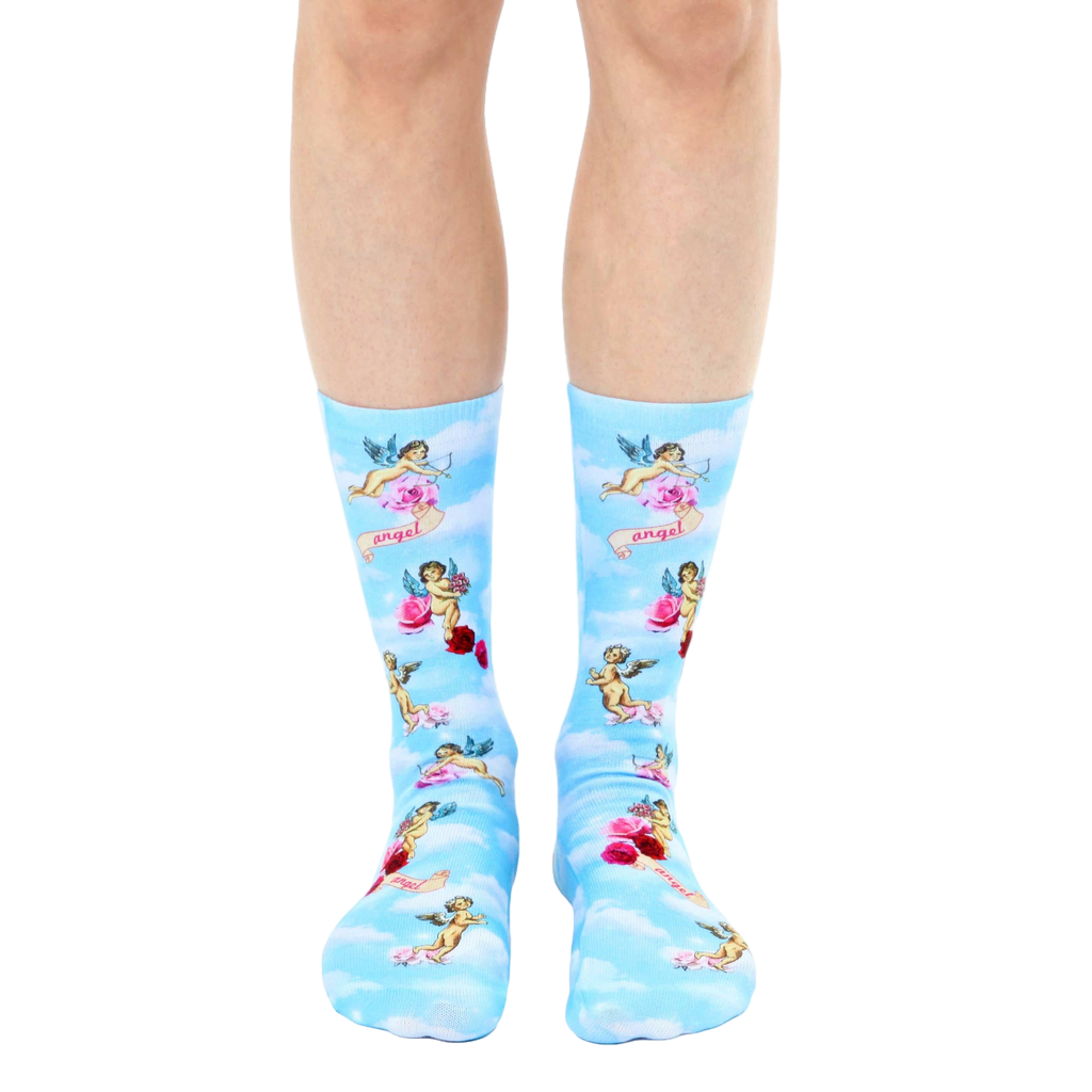 A pair of crew socks on a model's legs. Light blue background with cherubs, roses, and the word 'angel' printed on them. [lf]