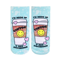 A pair of light blue tie-dye ankle socks feature a coffee cup design with a smiley face and the text 'I'm made of Coffee & Bad Decisions'.