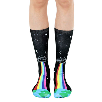 black star and planet socks with a spaceship shooting a rainbow down to earth on the front and earth on the bottom. fun crew socks for men and women.  