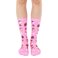 A pair of pink crew socks with a whimsical pattern of chocolate-covered strawberries. [lf]