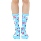 Crew socks in pastel blue featuring a whimsical pattern of pink pigs with wings flying among white clouds. [lf]