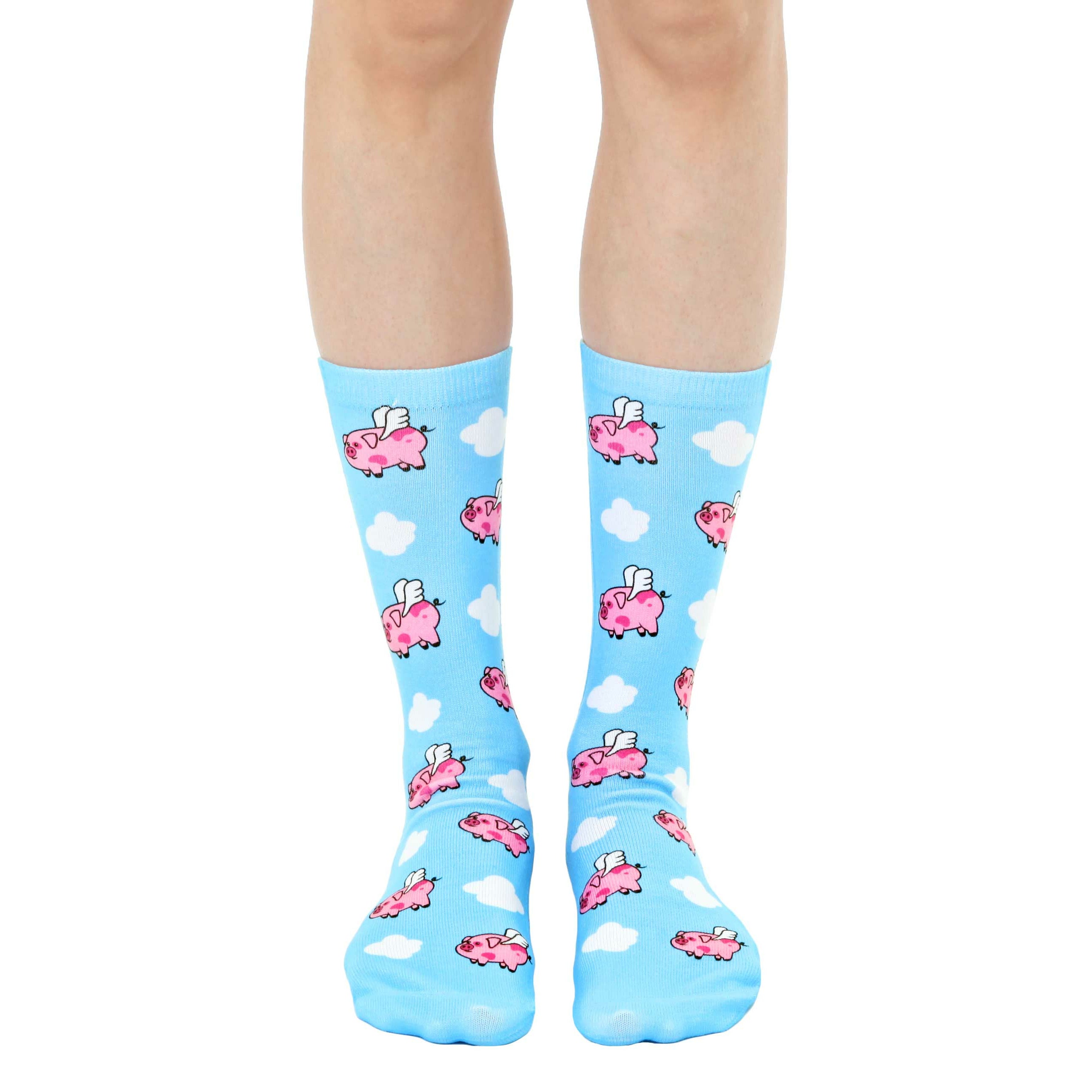 Crew socks in pastel blue featuring a whimsical pattern of pink pigs with wings flying among white clouds. [lf]