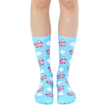 blue crew socks with cartoon pigs flying in a sky of white clouds.  