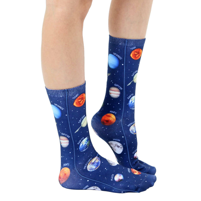 A pair of blue socks with an allover print of planets and celestial bodies. The planets are labeled with their names.
