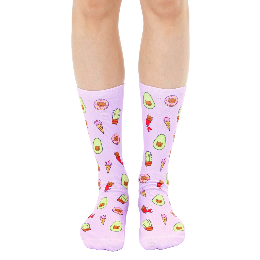 Lavender crew socks with an all-over print of illustrated cats dressed as avocados, ice cream cones, donuts, and cacti. [lf]