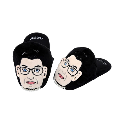 Pair of black plush RBG slippers.  The slippers feature a graphic of Ruth Bader Ginsburg's face and a pearl necklace; text says 'I Dissent'.