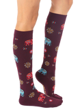 Lifestyle shot showing the Elephant knee-high socks on a model's legs. [lf]