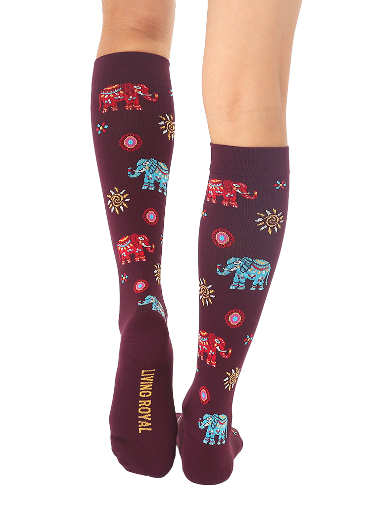 Close-up showcasing the back of the burgundy Elephant knee-high socks, with the 'Living Royal' logo visible. [lf]