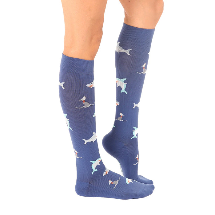A pair of blue knee-high compression socks with a pattern of cartoon sharks in shades of blue, gray, and orange.