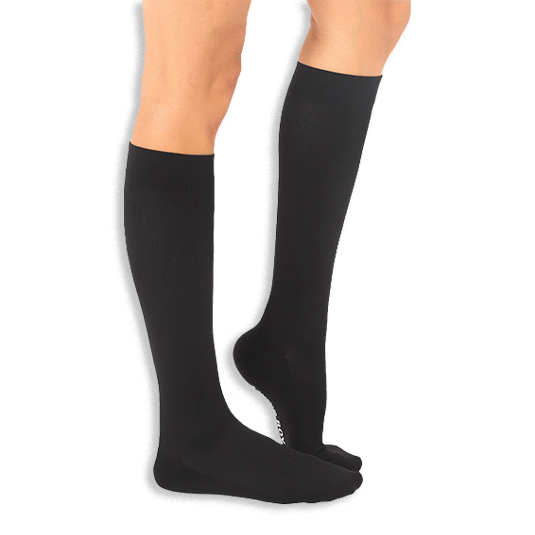 Side angle of solid black knee-high socks on legs, revealing a slight peek of white text on the sole.