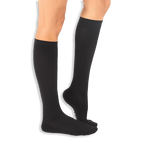 Side angle of solid black knee-high socks on legs, revealing a slight peek of white text on the sole.