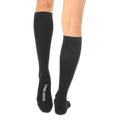 Back view of solid black knee-high socks with the words LIVING ROYAL printed in white on the bottom of the left foot.