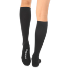 Back view of solid black knee-high socks with the words LIVING ROYAL printed in white on the bottom of the left foot.