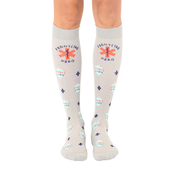frontline hero knee-high socks show support for first responders in gray with blue, red, and orange plus signs, "frontline hero" and "saving lives" text  