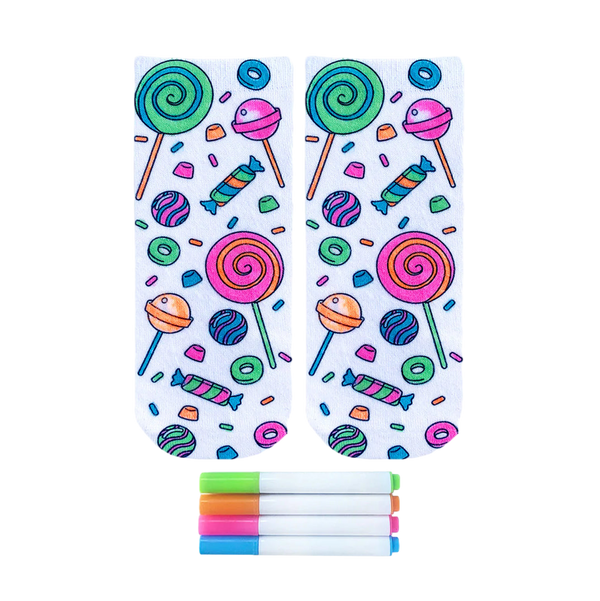 Pair of ankle socks featuring a candy-themed design in bright pink, green, blue, and orange.  Lollipops, gummies, and other sweets are scattered on a white background. Includes four fabric markers. [lf]