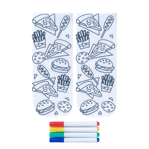 Pair of white crew socks featuring outline drawings of junk food like pizza, burgers, and fries.  Includes four fabric markers for coloring. [lf]