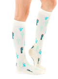 Lifestyle shot of a person wearing the Cactus Knee-High Socks, showcasing how they look when worn. [lf]
