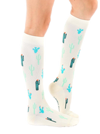 Lifestyle shot of a person wearing the Cactus Knee-High Socks, showcasing how they look when worn. [lf]